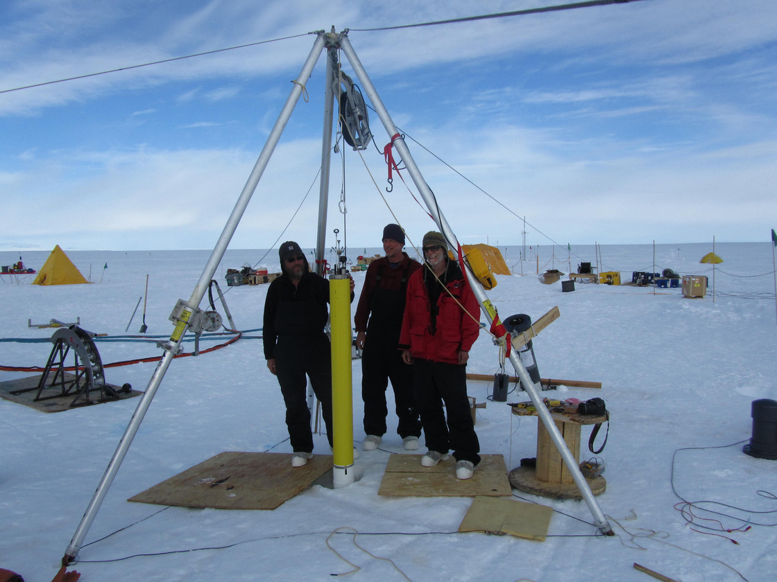 The Naval Postgraduate School team deploys ocean monitoring instruments through a bore hole into the ocean cavity below.