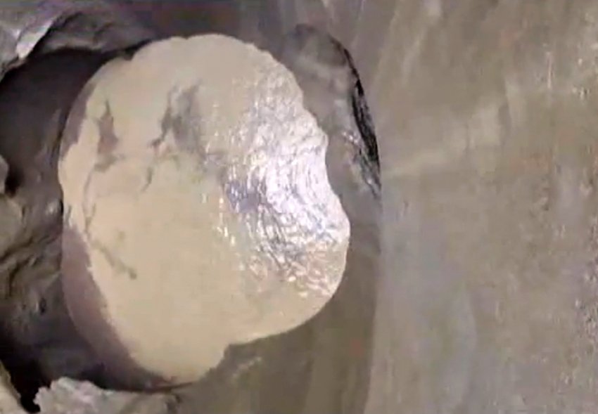 The sink hole ground is covered with ice